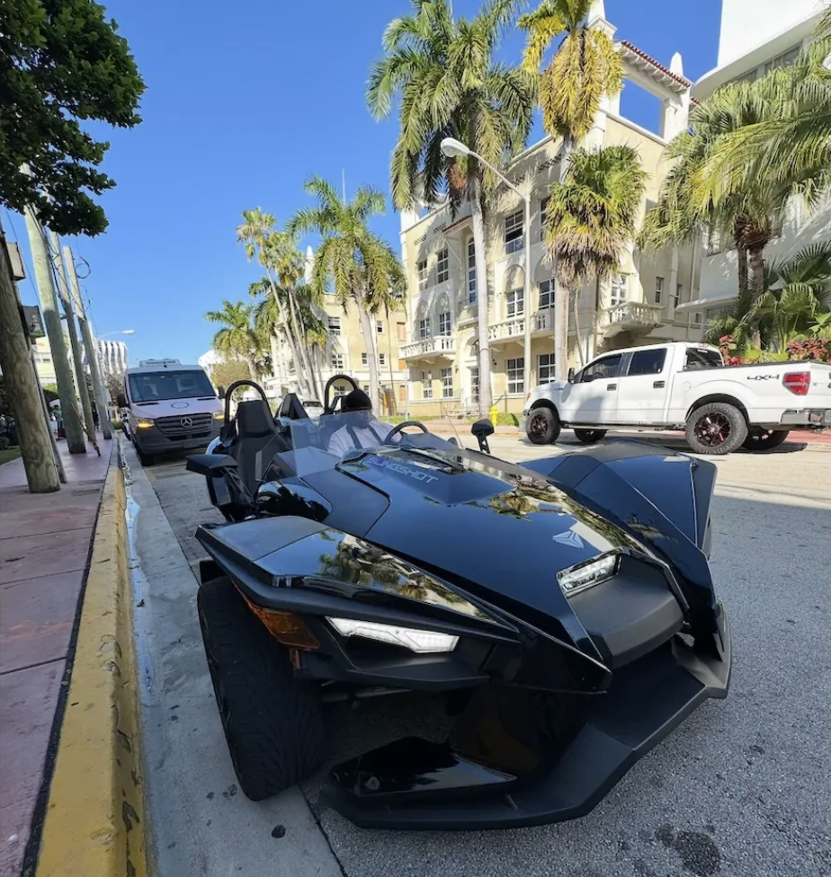 Polaris Slingshot rental on Miami Beach street